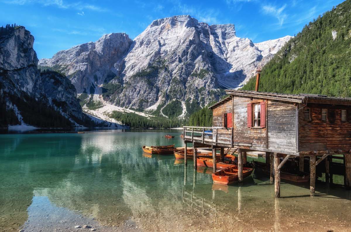 Lago di Braies with turquoise water and wooden boathouse in the Italian Dolomites, one of the top places to visit in Europe near Tre Cime di Lavaredo
