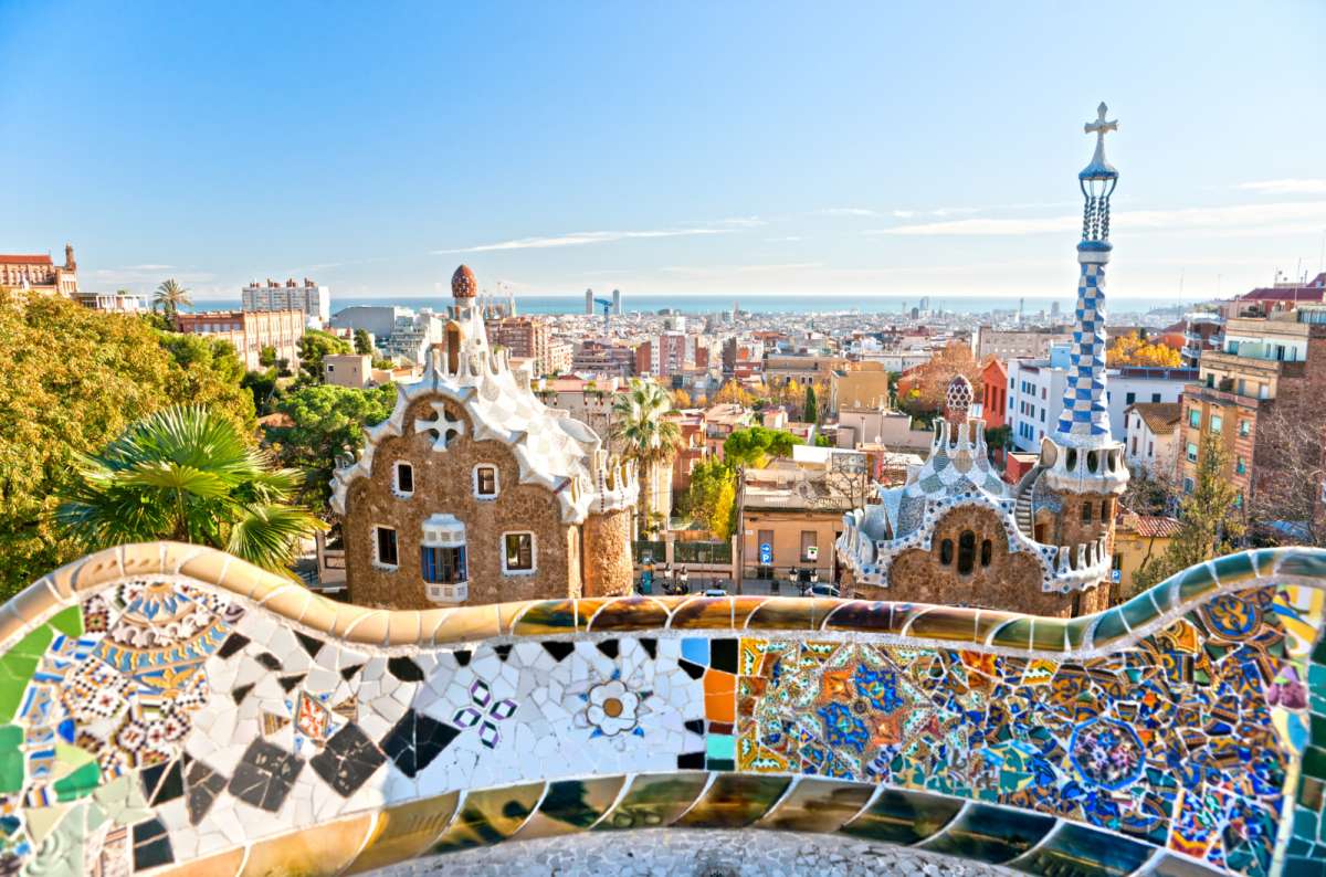 Mosaic terrace and fairytale towers at Park Güell, Barcelona, Spain, overlooking the city and Mediterranean Sea