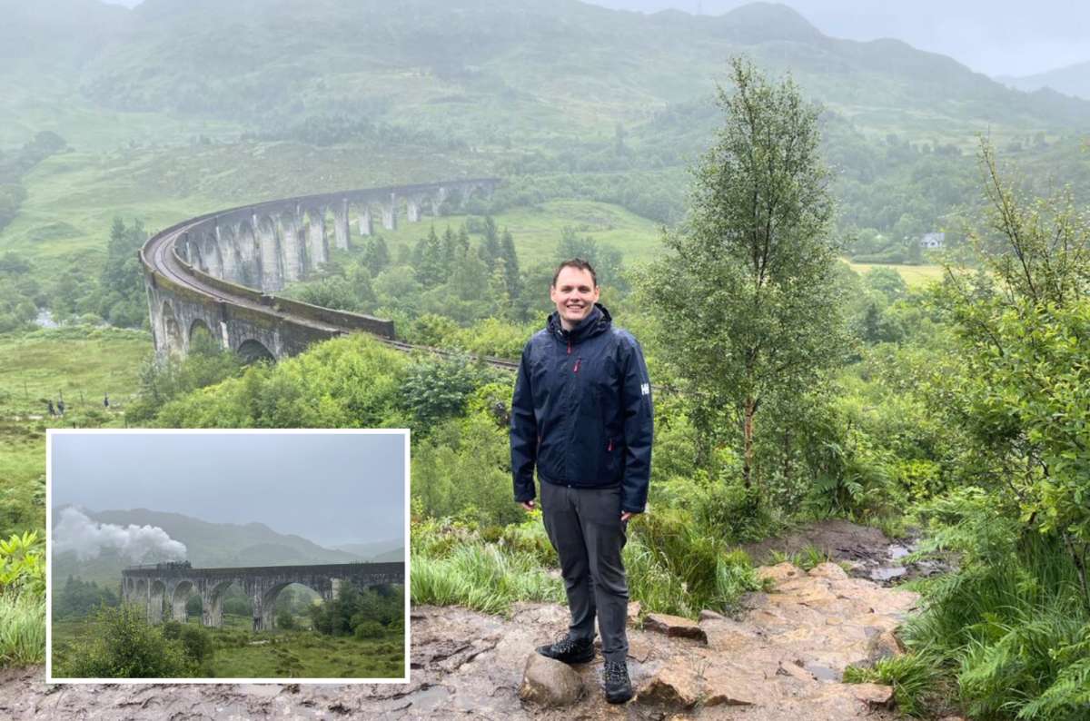 Steam train crossing Glenfinnan Viaduct in the Scottish Highlands, stone arches over a green valley