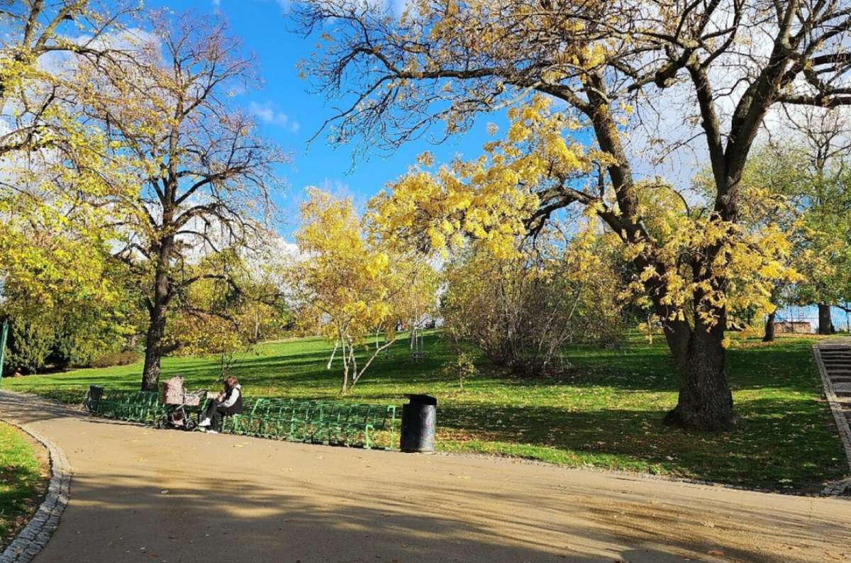 People relaxing on benches in Riegrovy sady park in Prague, Czech Republic