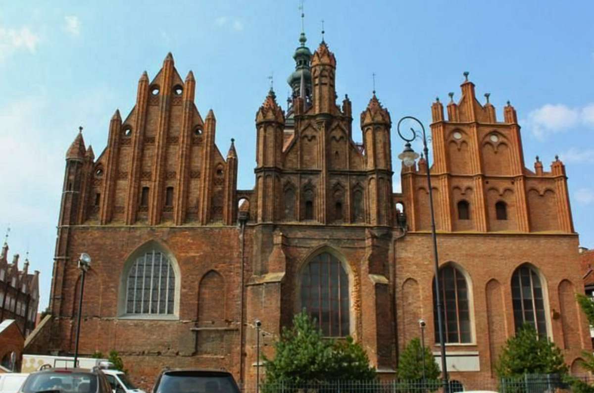 Exterior of St. Bridget’s Church in Gdańsk, Poland, a Gothic red-brick basilica known for its amber altar, photo by Next Level of Travel