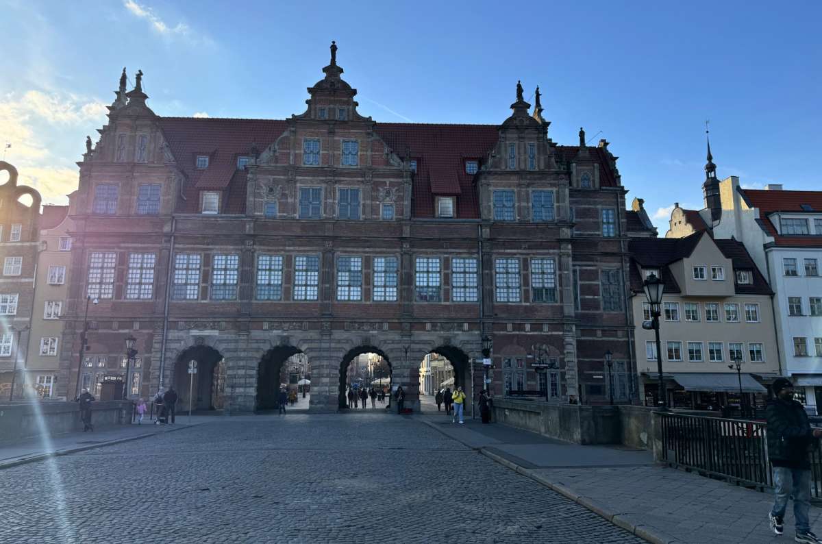 Green Gate (Zielona Brama) in Gdansk, Poland, with a historic brick facade and arched passageways, photo by Next Level of Travel
