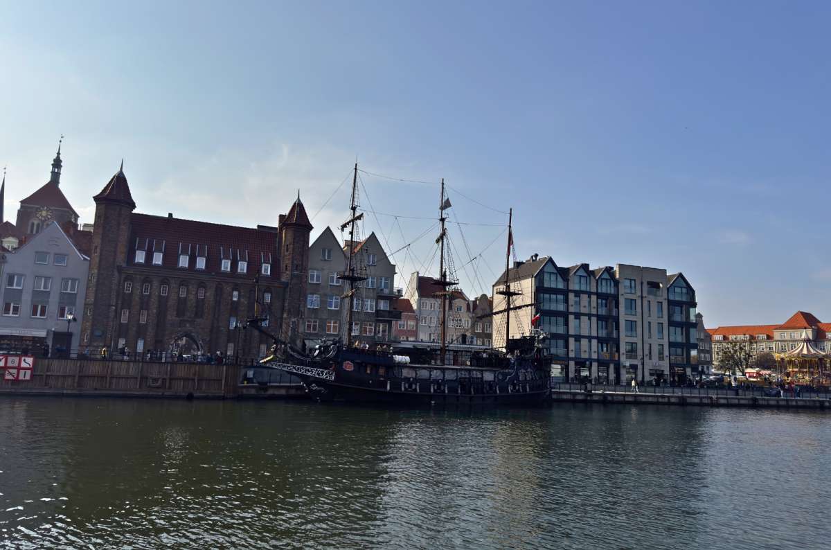 Historic ship on the Motława River in Gdansk, Poland near the National Maritime Museum and Old Town waterfront buildings, photo by Next Level of Travel