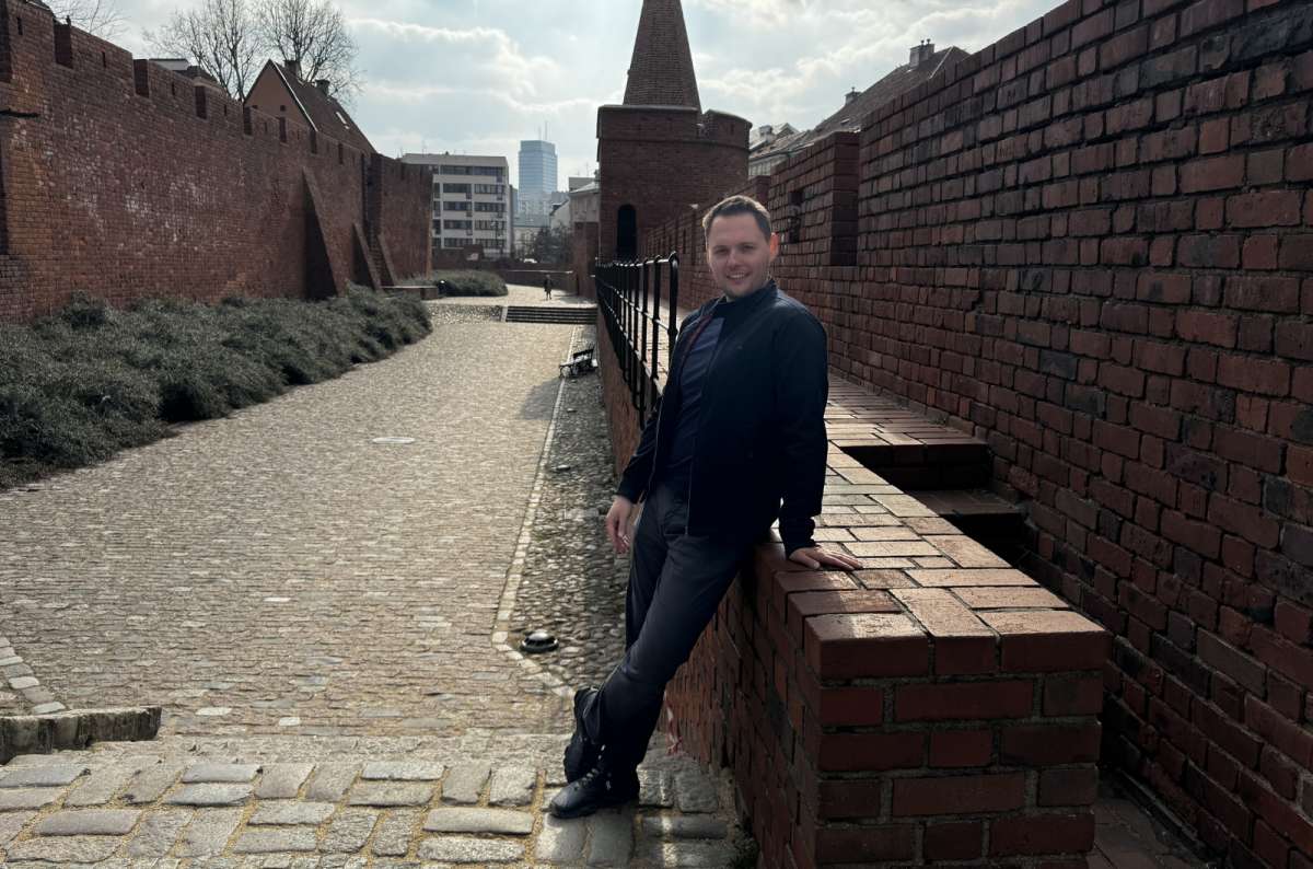 a photo of a tourist posing by the Warsaw city walls, Poland, photo by Next Level of Travel