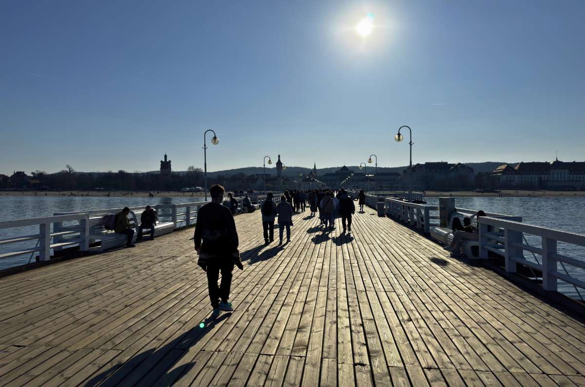 Wooden pier with people walking toward the sea at Sopot Pier, Sopot, Poland, photo by Next Level of Travel