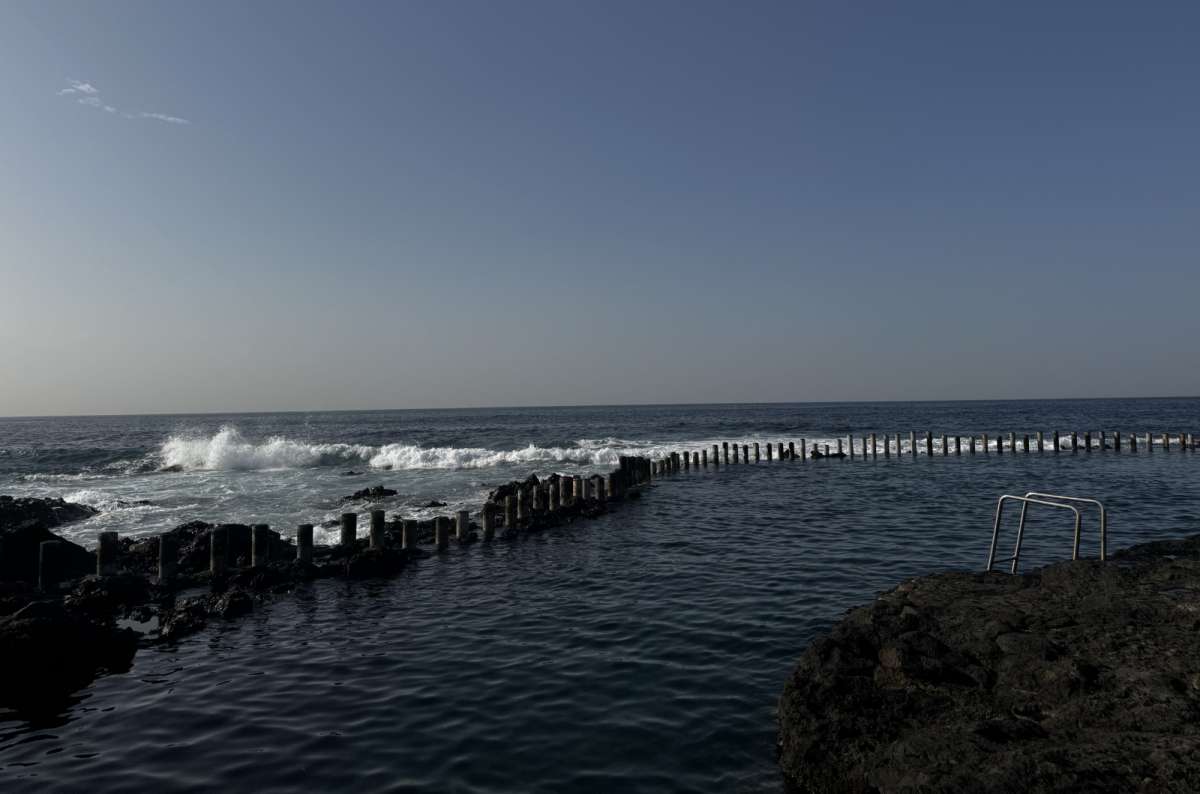 a photo of the Agaete Piscina Natural showing the waves crashing against the rocks, Gran Canaria, Canary Islands, photo by Next Level of Travel