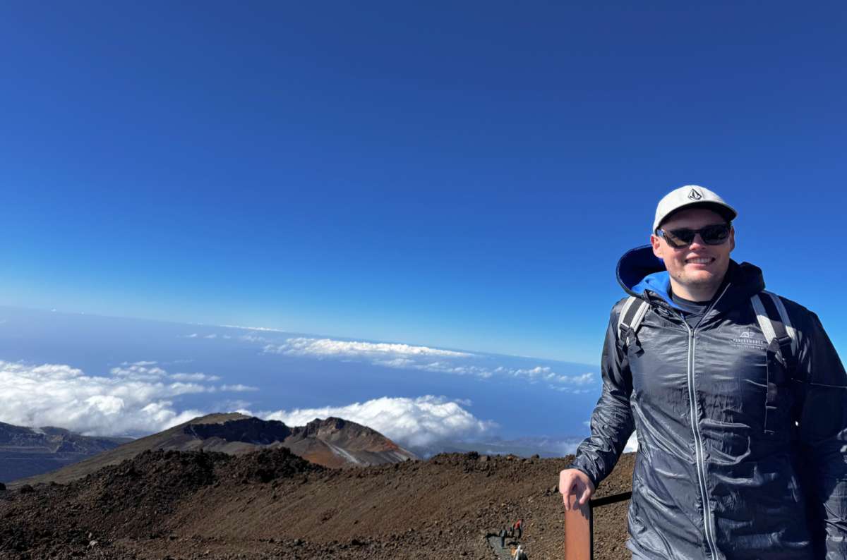 a photo of a tourist posing at Mt. Teide with the rest of Teide National Park visible in the background, Canary Islands, photo by Next Level of Travel