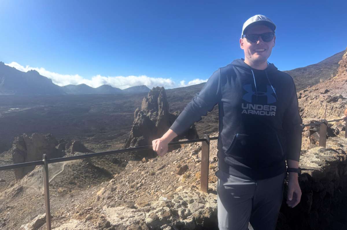 a photo of a tourist posing in front of Roques de García in Teide National Park, Canary Islands, photo by Next Level of Travel