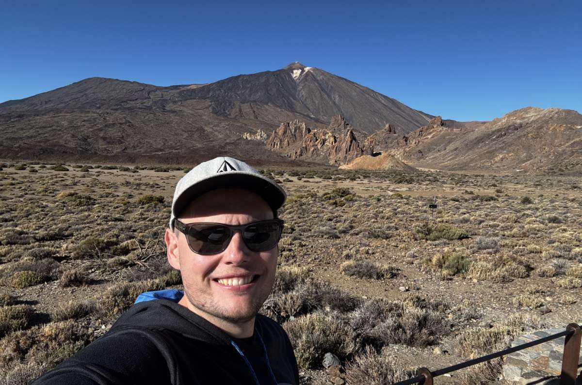 a photo of a tourist posing in Teide National Park with Llano de Ucanca in the background, Canary Islands, photo by Next Level of Travel