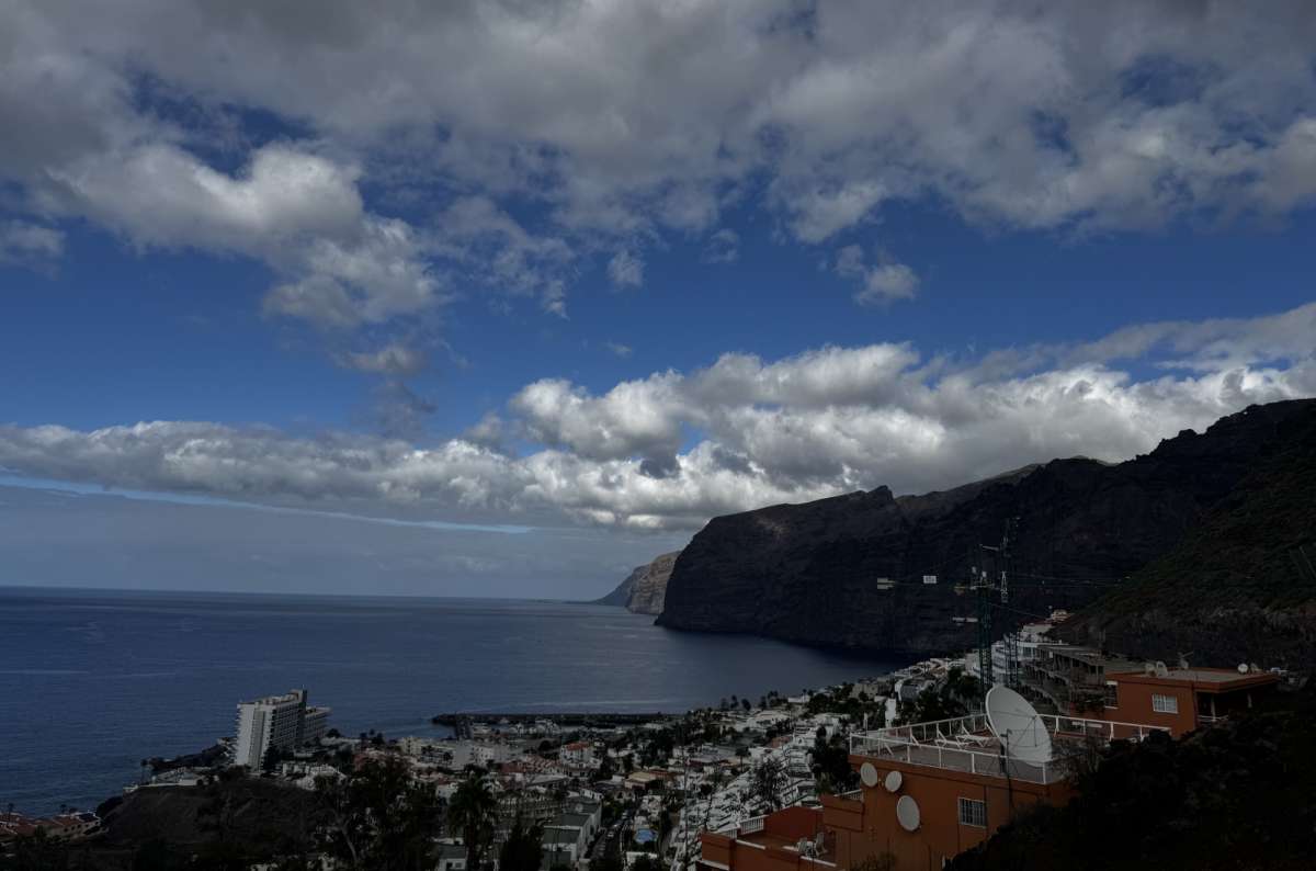 a photo of Los Gigantes Cliffs, and the city near them, Canary Islands, photo by Next Level of Travel
