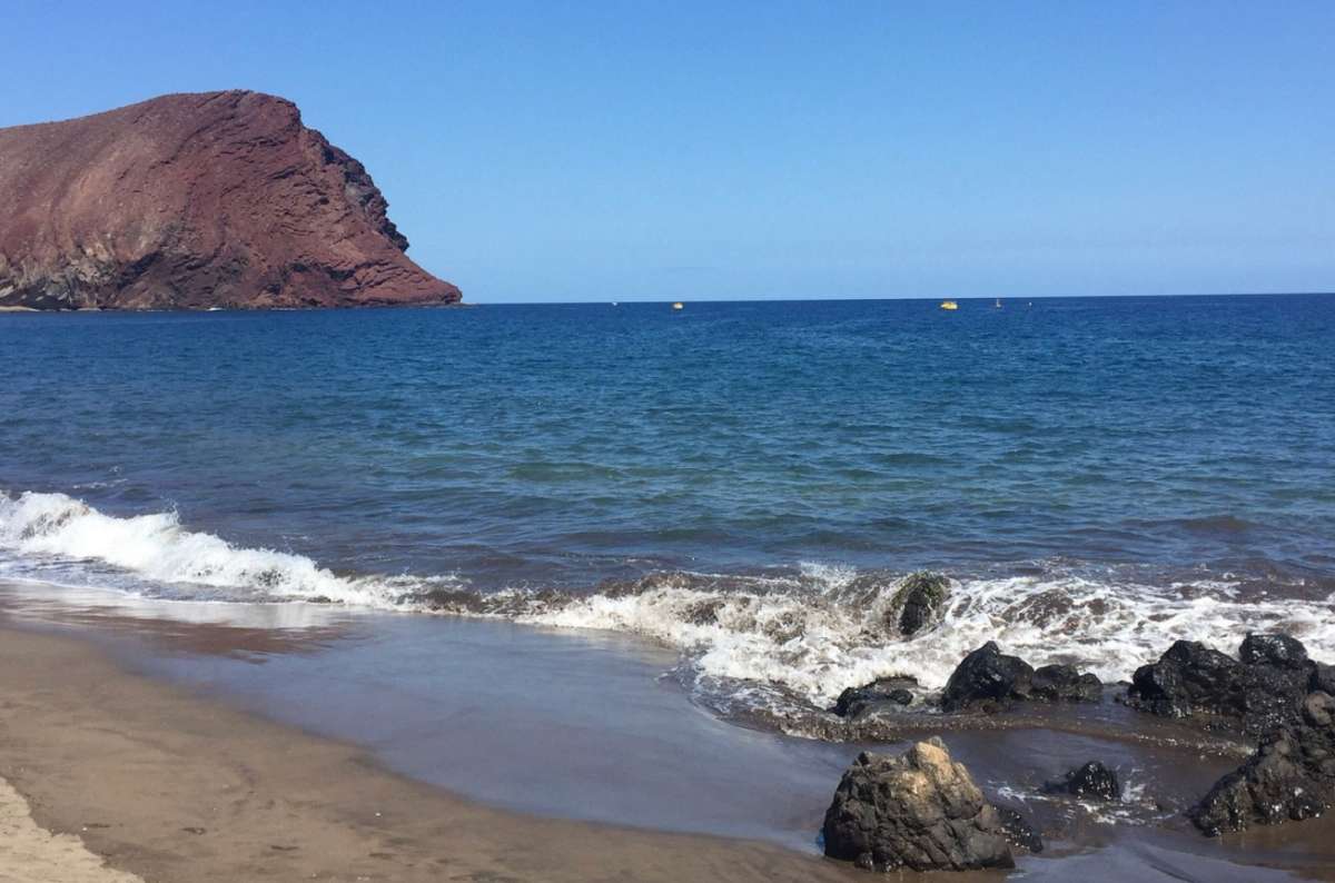 a photo of Montaña Roja and the sea right next to it, Canary Islands