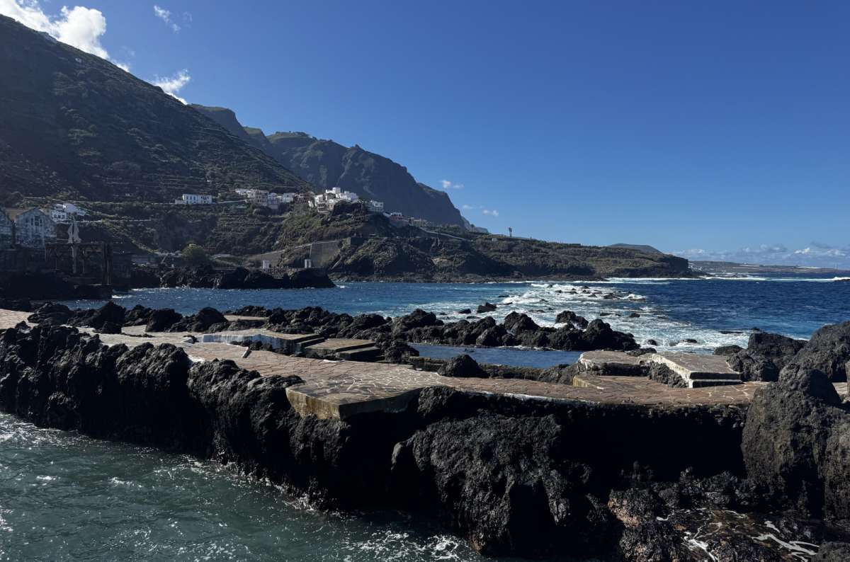 a photo of the Garachico coastline with the town and sea visible in the background, Canary Islands, photo by Next Level of Travel