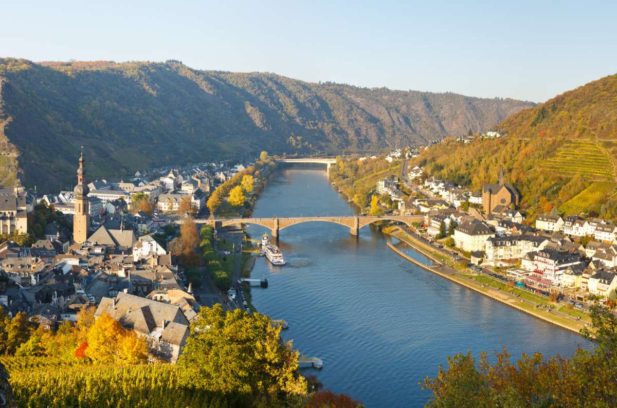 a photo of the city of Cochem showing the characteristic architecture and the river running through the town, Germany