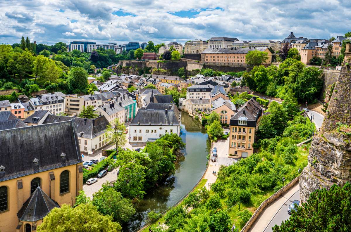 a photo of the city of Luxembourg showing the characteristic architecture and the river running through the town, Luxembourg