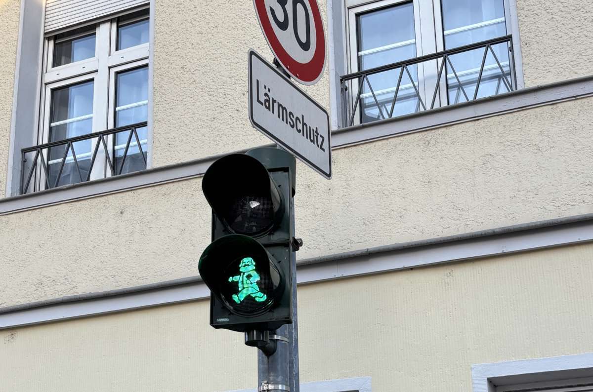 a photo of the green traffic light shaped like Karl Marx, Trier, Germany, photo by Next Level of Travel