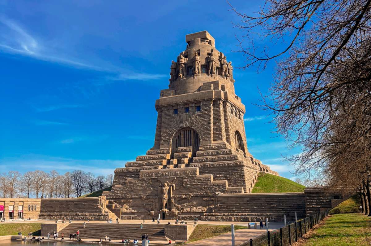 Völkerschlachtdenkmal monument in Leipzig, Germany under a bright blue sky, photo by Next Level of Travel