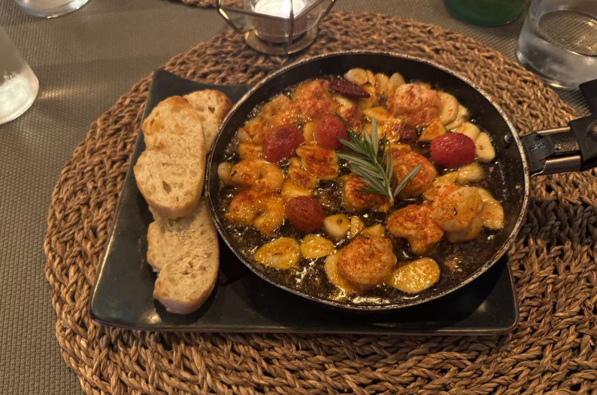 a photo of a paella served with some bread at playa de las Nieves, Canary Islands, photo by Next Level of Travel