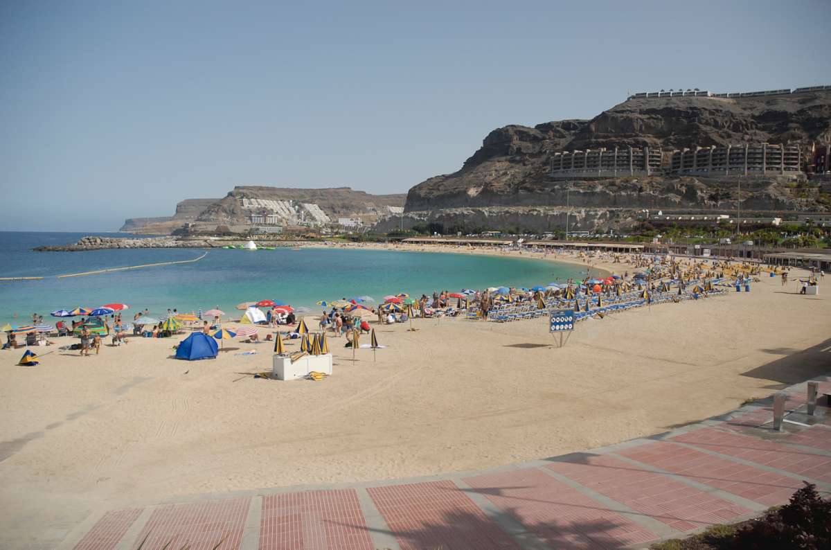 a photo of playa de Amadores in Gran Canaria, showing the calm beach and clear water, Canary Islands