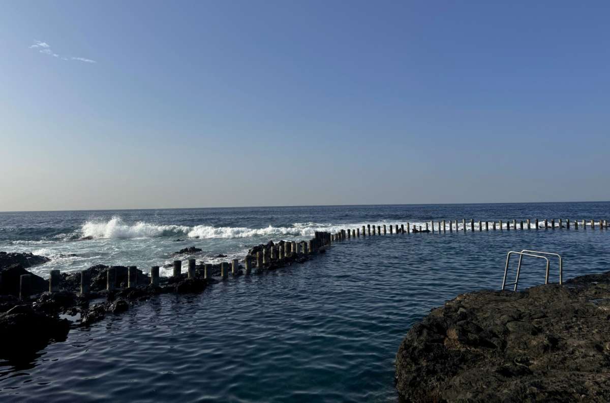 a photo of the Agaete pools showing the endless sea in the background complemented by crashing waves, Canary Islands, photo by Next Level of Travel