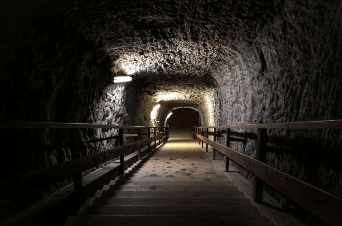 a photo from the Berchtesgaden Salt Mines, showing a staircase leading deep into the mine, Germany, photo by Next Level of Travel