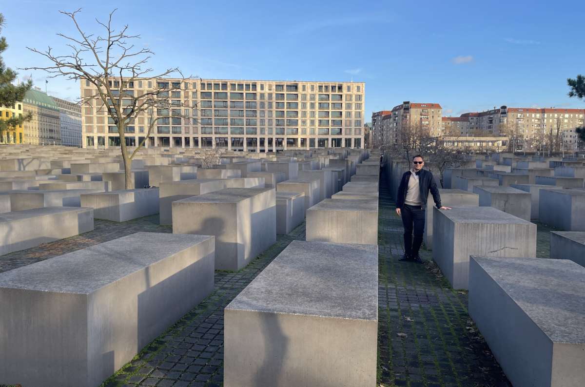 a photo from the Holocaust memorial with a tourist posing among the stones, Berlin, Germany, photo by Next Level of Travel
