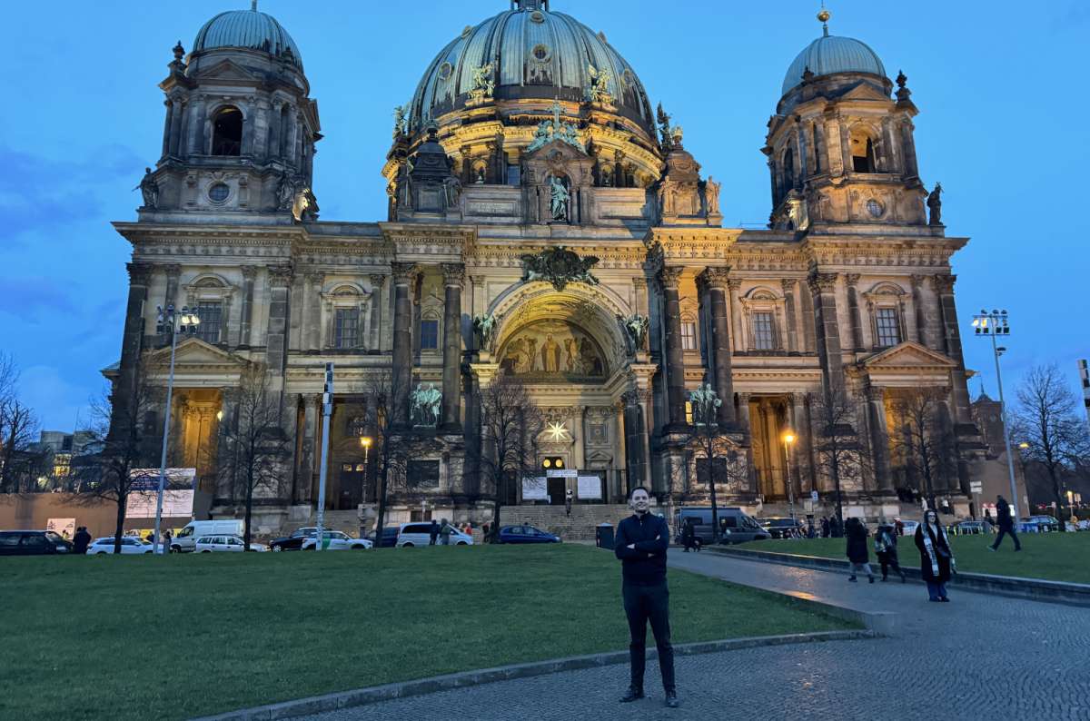 a photo of a tourist posing in front of the Berlin Cathedral, Germany, photo by Next Level of Travel
