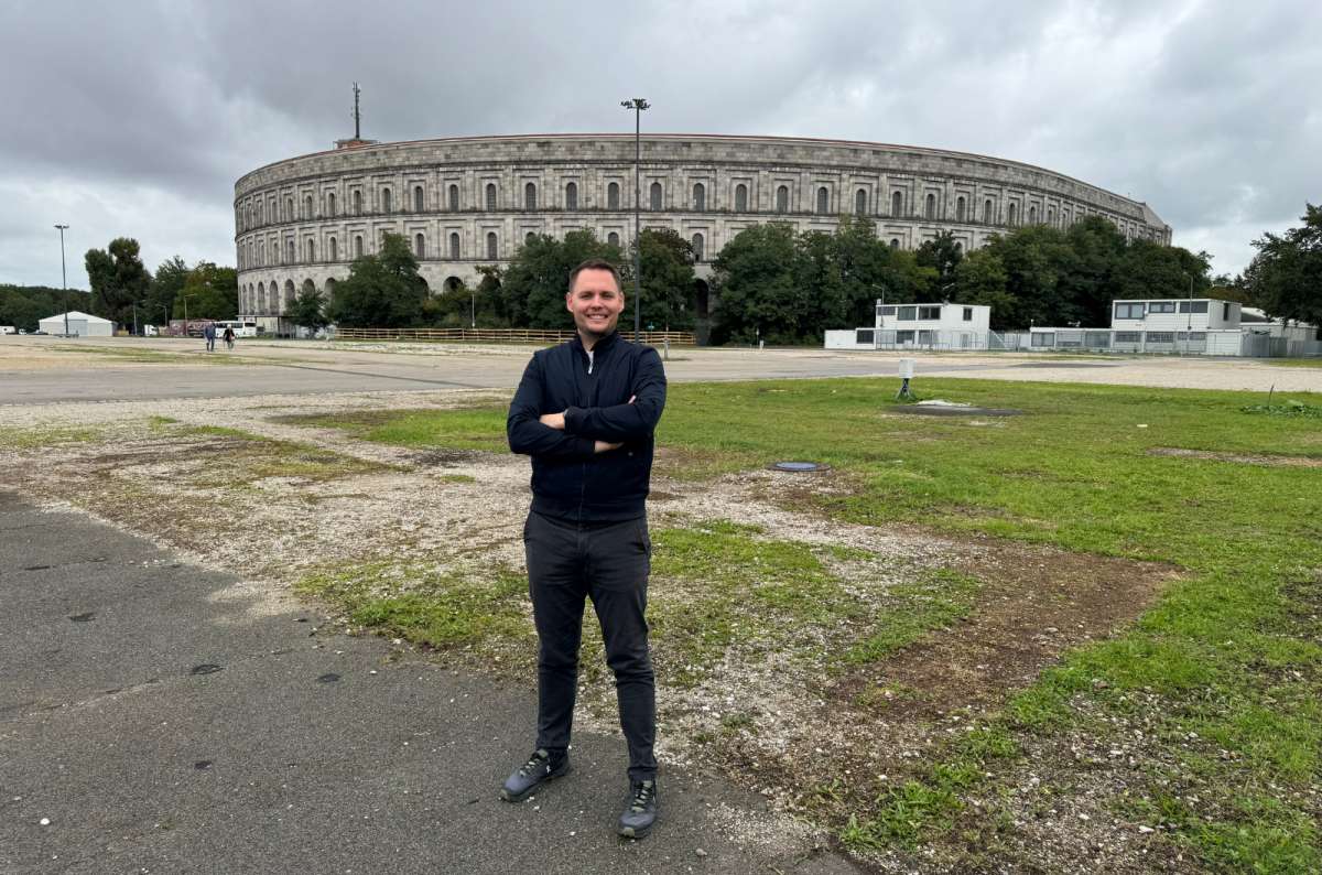 a photo of a tourist posing in front of the Nazi Rally Grounds, Nuremberg, Germany, photo by Next Level of Travel