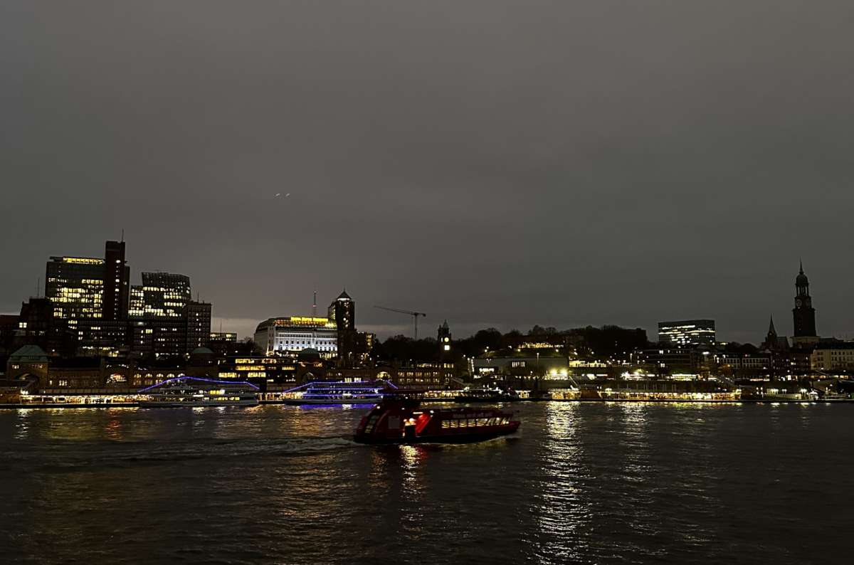 a photo of the city of Hamburg showing a cruise boat on the river at night, Germany, photo by Next Level of Travel