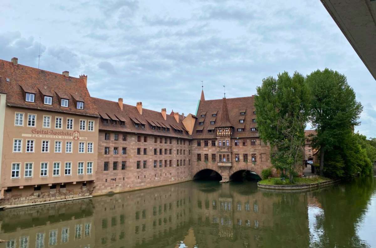 Historic Heilig-Geist-Spital building over the Pegnitz River in Nuremberg, Germany, photo by Next Level of Travel