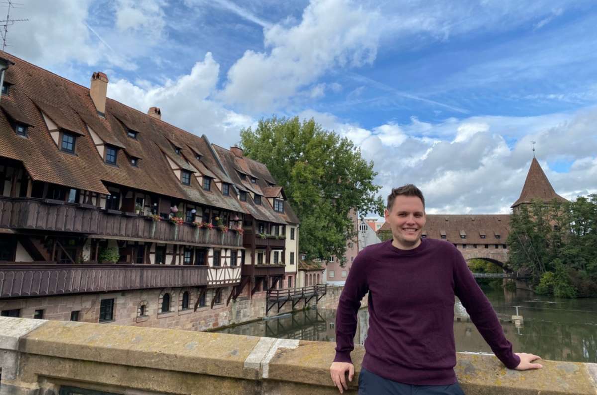 Tourist near the Henkersteg bridge and Pegnitz River in Nuremberg, Germany, photo by Next Level of Travel