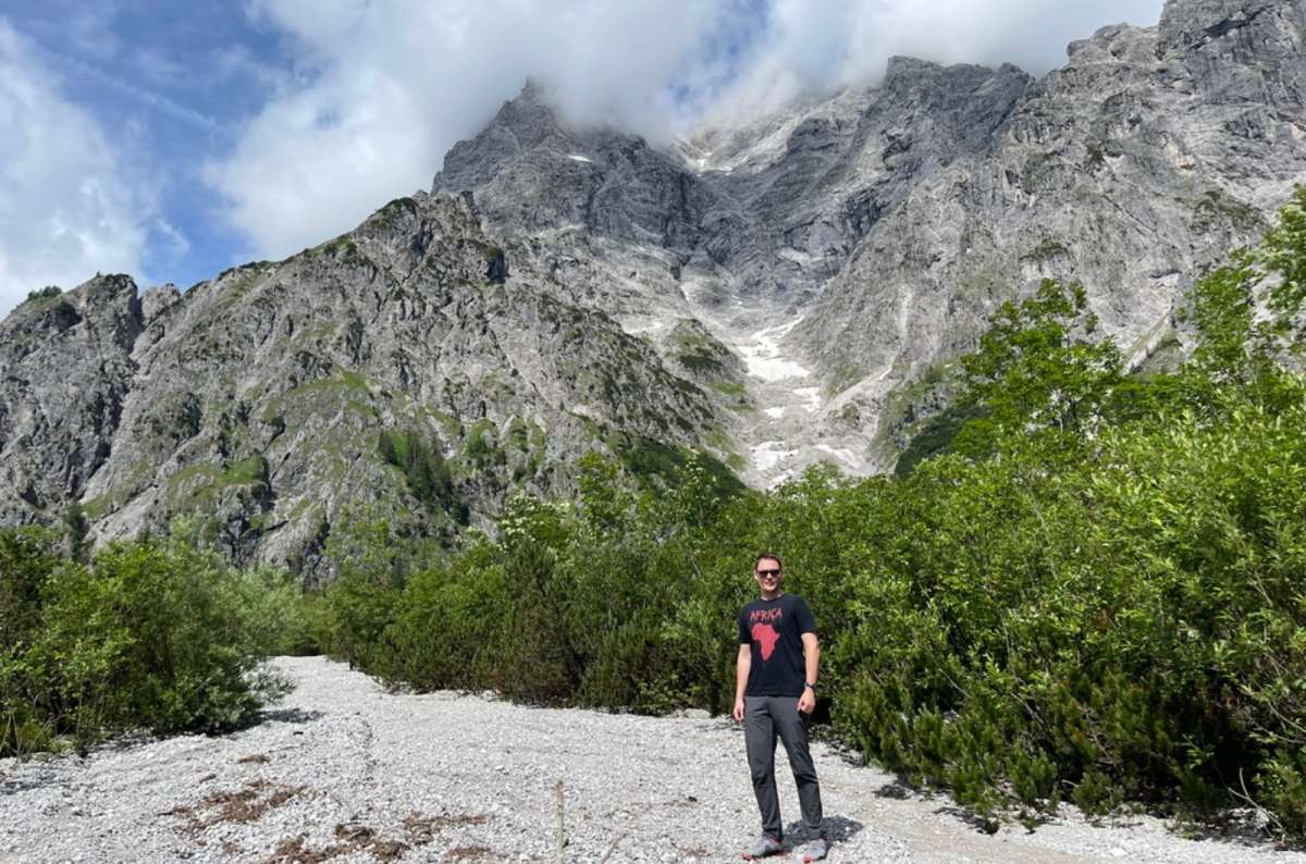 Tourist standing below dramatic mountain peaks in the Bavarian Alps near Garmisch-Partenkirchen, Germany, photo by Next Level of Travel