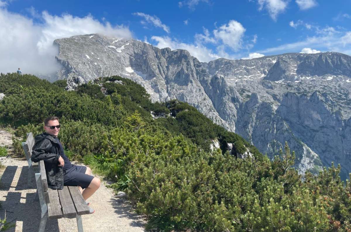 Visitor relaxing on a bench with mountain views near Eagle’s Nest in Berchtesgaden, Bavaria, Germany, photo by Next Level of Travel