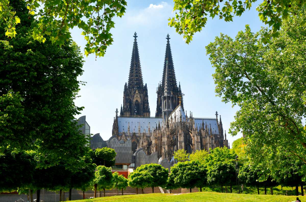 a photo of the Cologne Cathedral with the park in front of it, Germany