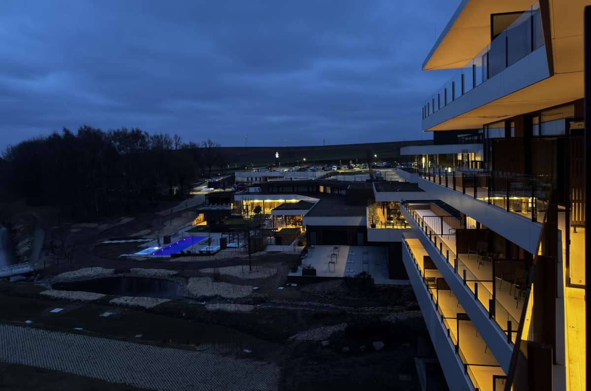 a photo of a modern hotel resort, Anatura at dusk, showing the modern exterior and the outdoor pool, Luxembourg, photo by Next Level of Travel