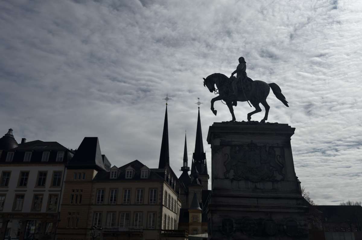 a photo of the equestrian statue of Grand Duke William II silhouetted against the sky, Place Guillaume II, Luxembourg, photo by Next Level of Travel
