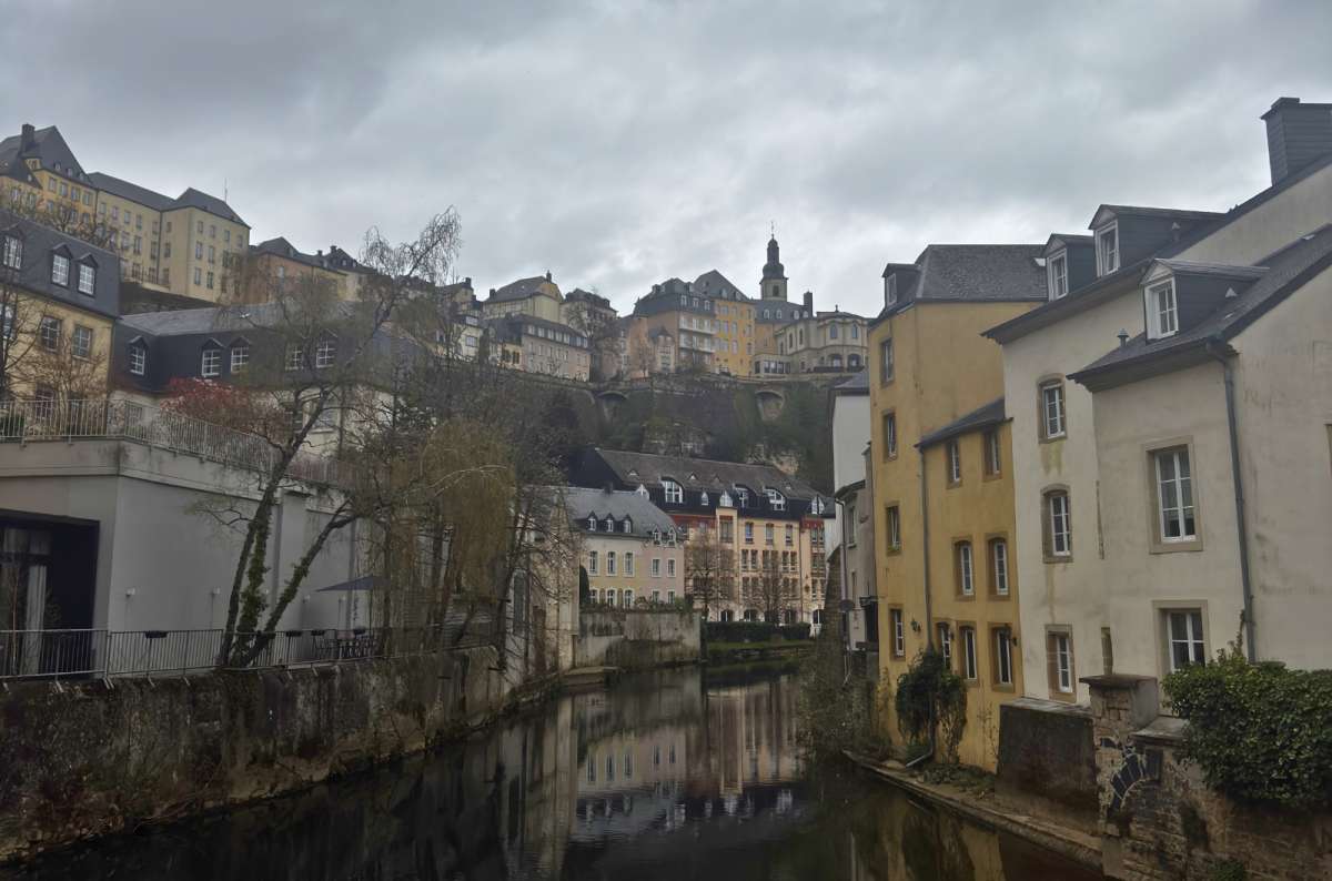a photo of the Grund neighbourhood along the Alzette river, showing the difference in elevation between the upper and lower parts of the city, Luxembourg, photo by Next Level of Travel