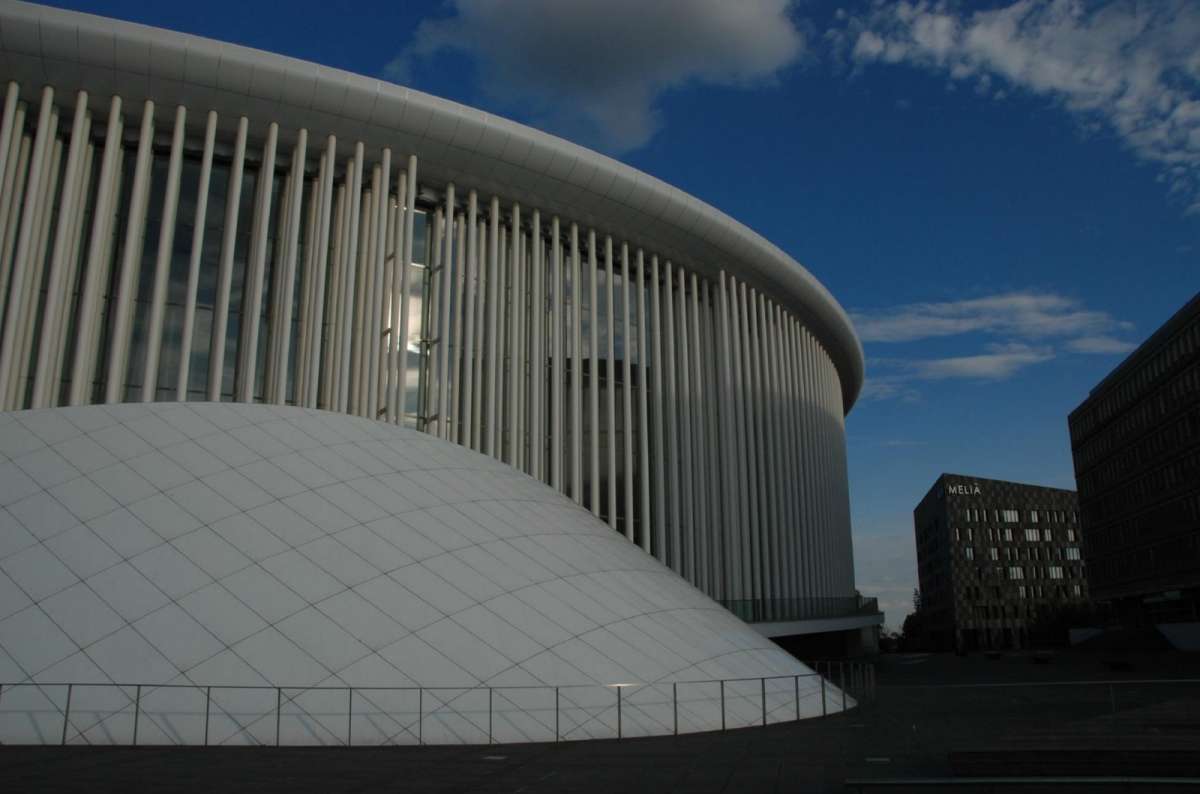 a photo of the Philharmonie Luxembourg concert hall exterior showing the decorative white columns surrounding the structure, Kirchberg, Luxembourg City, Luxembourg