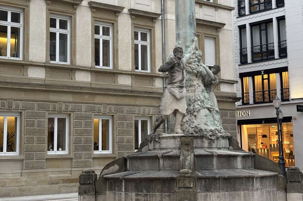 A fountain and townhouses on a central square, Luxembourg City, Luxembourg, photo by Next Level of Travel 