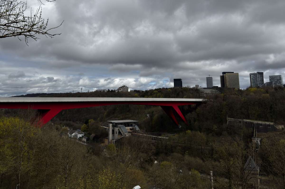 The red bridge and modern city rising above the green valley, Luxembourg City, Luxembourg, photo by Next Level of Travel