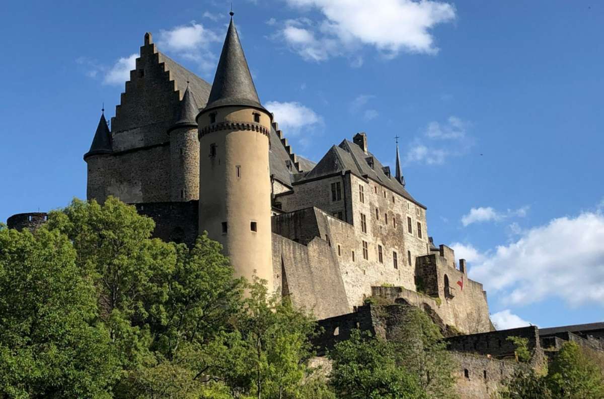 Vianden Castle rising above the town of Vianden, Luxembourg, one of the best places to stay in northern Luxembourg