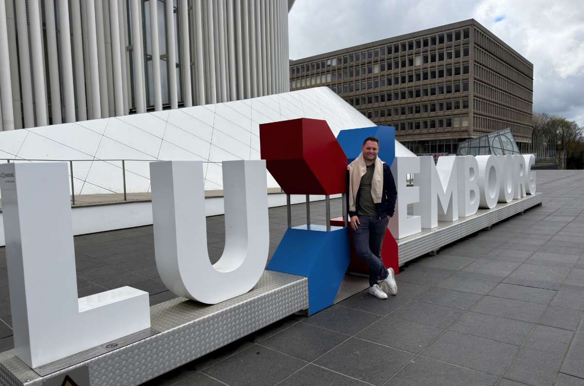 Visitor standing by the large 