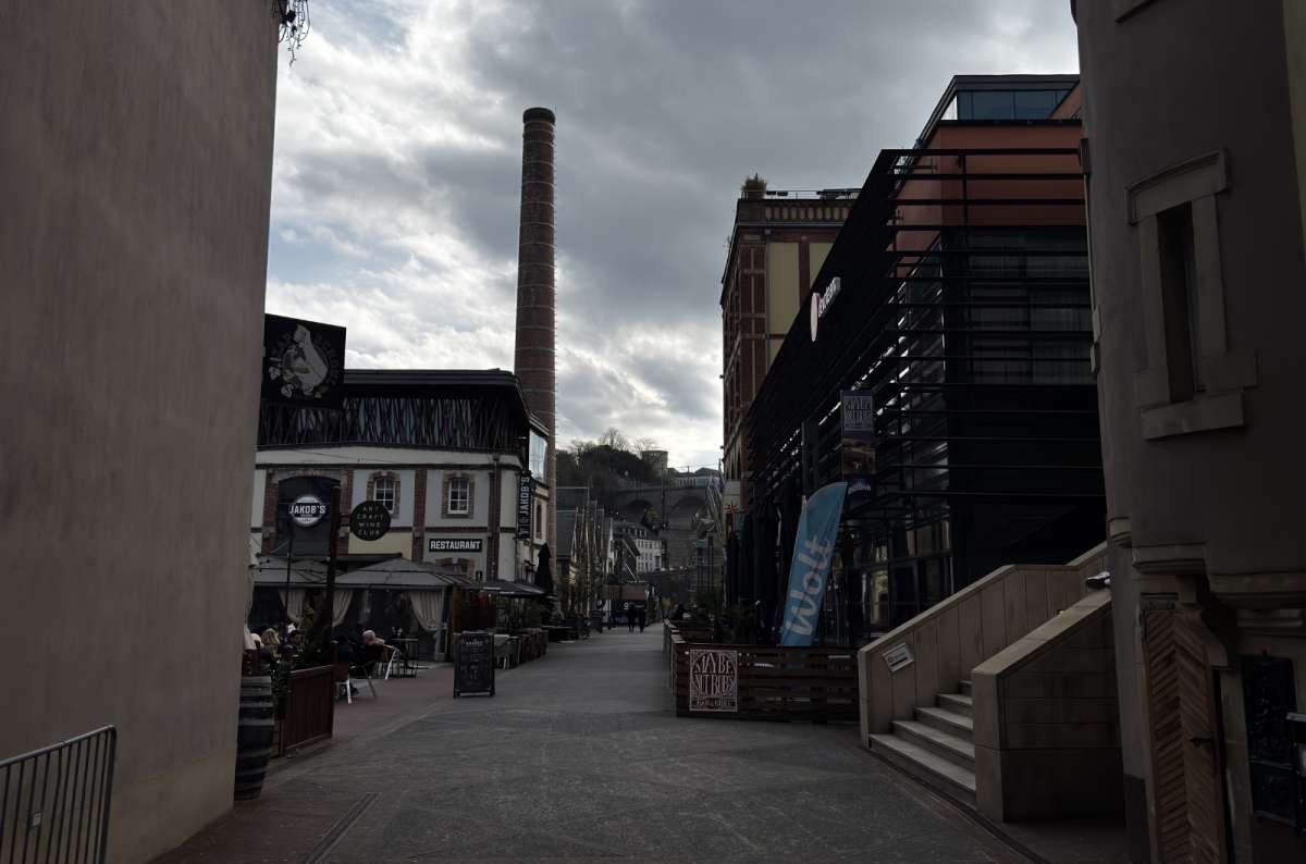 a photo of the street outside of the city center with houses and restaurants visible in th background, Luxembourg, photo by Next Level of Travel
