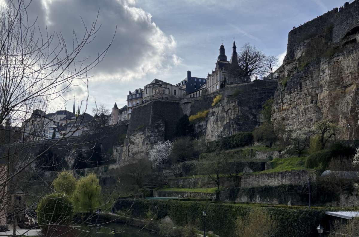 the view from the walk along the Alzette, showing the Kirchberg and the upper part of the city in the background, Luxembourg, photo by Next Level of Travel
