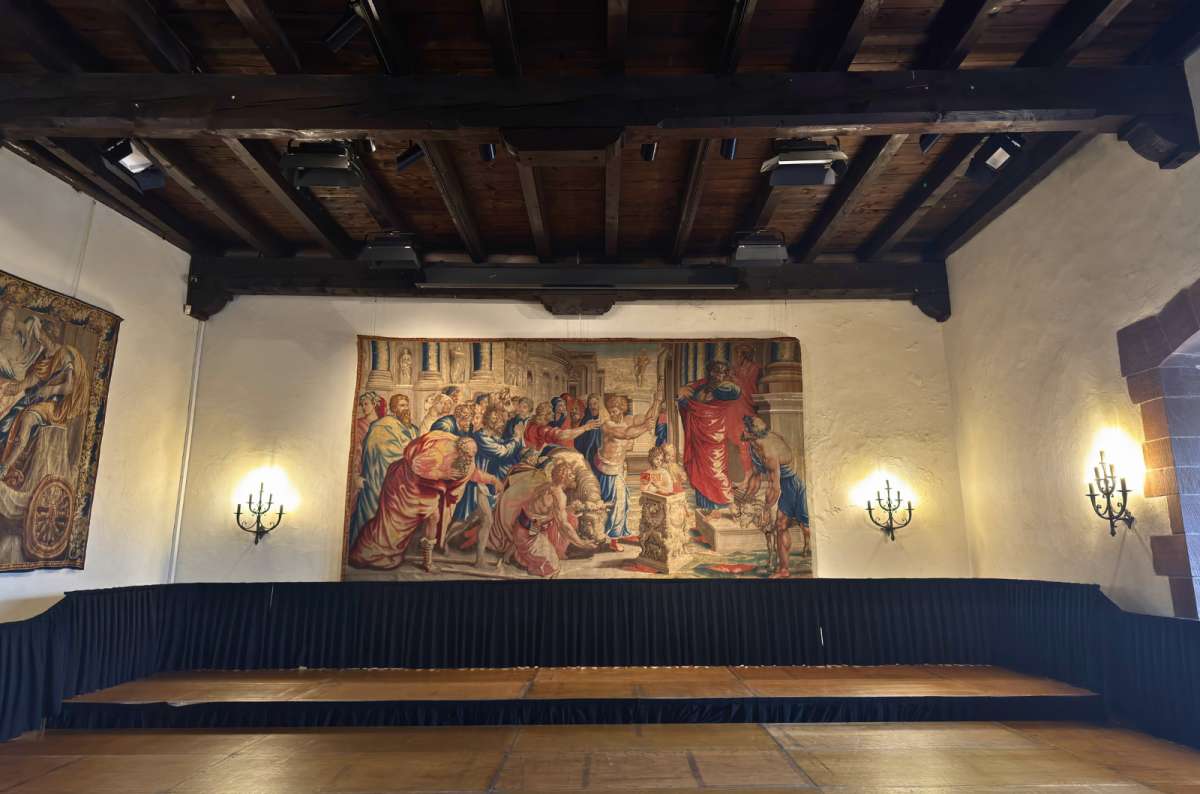 Ceremonial hall with a large historic tapestry inside Vianden Castle in Vianden, Luxembourg, photo by Next Level of Travel