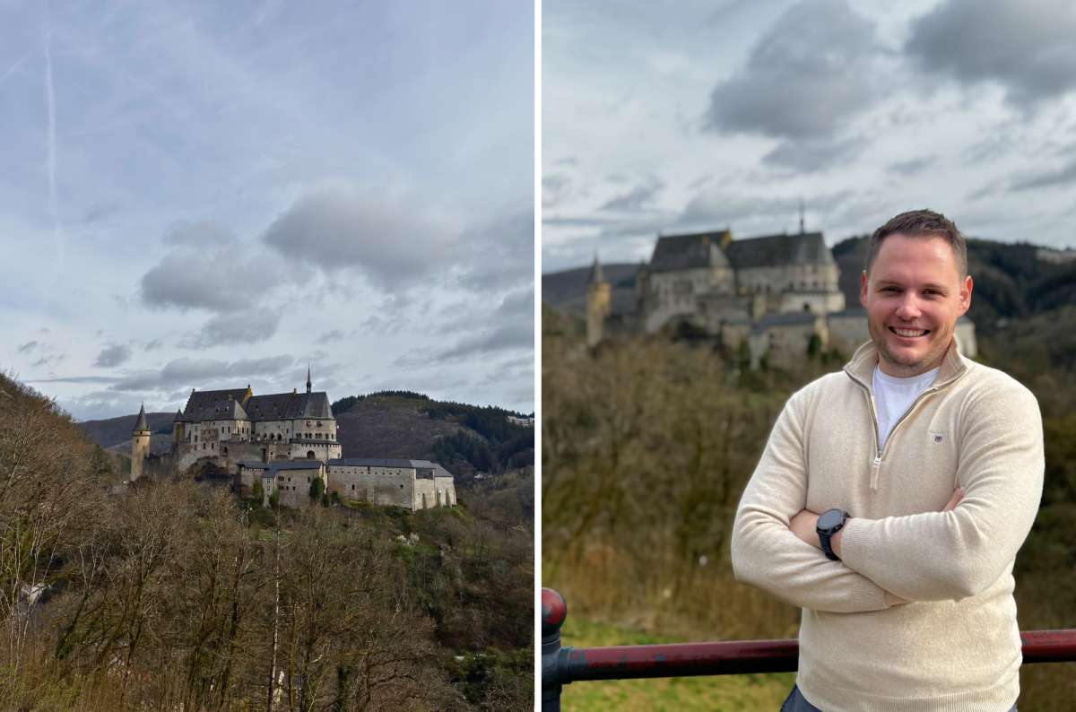 Panoramic view of Vianden Castle and a visitor at a scenic viewpoint overlooking the castle in Vianden, Luxembourg, photo by Next Level of Travel