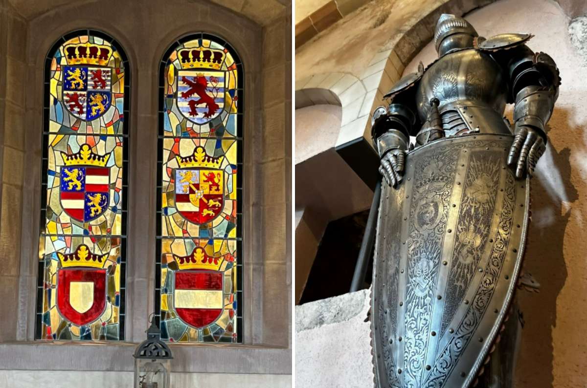 Stained glass windows with historic coats of arms and a suit of medieval armor inside Vianden Castle, Luxembourg