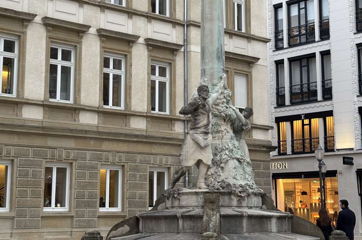 A fountain and townhouses in a central city square, Luxembourg City, Luxembourg, photo by Next Level of Travel