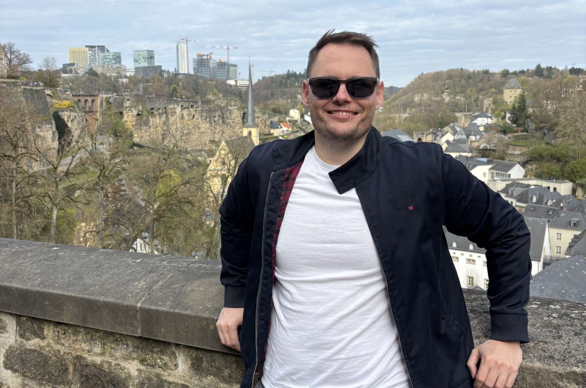 A tourist at the Corniche overlooking the Grund quarter and the Alzette valley, Luxembourg City, Luxembourg, photo by Next Level of Travel 