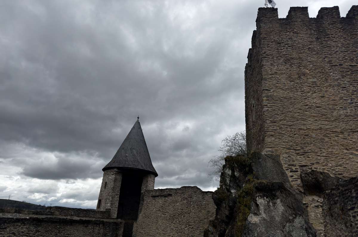 The ruined walls and towers of Bourscheid Castle above the Sûre valley, Luxembourg, photo by Next Level of Travel