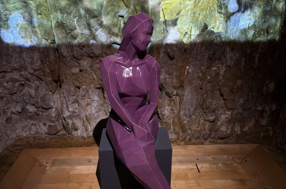 A lamplit museum gallery with a display of a mermaid statue, Luxembourg City, Luxembourg, photo by Next Level of Travel
